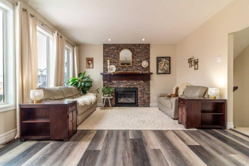 597 Aquitania Boulevard West, Lethbridge, AB - Indoor Photo Showing Living Room With Fireplace