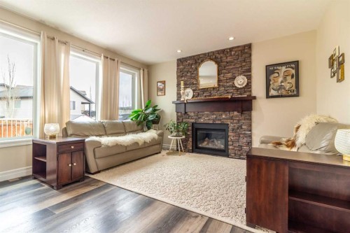597 Aquitania Boulevard West, Lethbridge, AB - Indoor Photo Showing Living Room With Fireplace