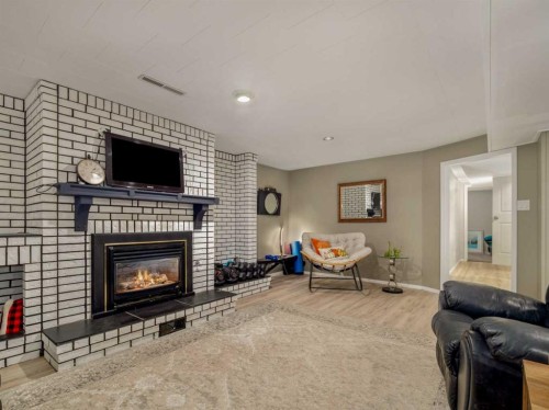 1707 Lakemount Boulevard South, Lethbridge, AB - Indoor Photo Showing Living Room With Fireplace