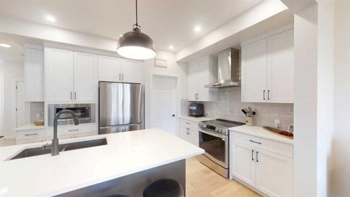 28 Aster Link, Okotoks, AB - Indoor Photo Showing Kitchen With Double Sink With Upgraded Kitchen