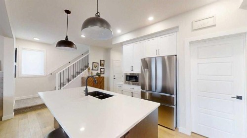 28 Aster Link, Okotoks, AB - Indoor Photo Showing Kitchen With Double Sink With Upgraded Kitchen