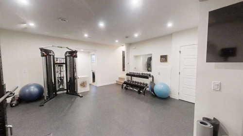 28 Aster Link, Okotoks, AB - Indoor Photo Showing Gym Room