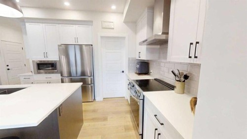 28 Aster Link, Okotoks, AB - Indoor Photo Showing Kitchen With Upgraded Kitchen
