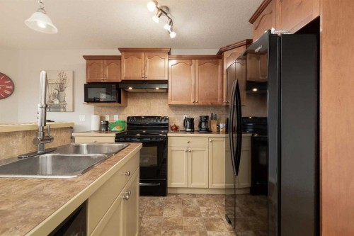 4405 Lake Drive, Coalhurst, AB - Indoor Photo Showing Kitchen With Double Sink