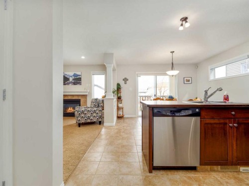 1601 Coalbanks Boulevard West, Lethbridge, AB - Indoor Photo Showing Kitchen With Fireplace With Double Sink