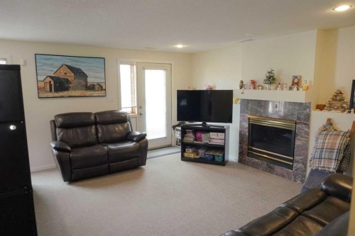 46 Heritage Place West, Lethbridge, AB - Indoor Photo Showing Living Room With Fireplace