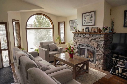 46 Heritage Place West, Lethbridge, AB - Indoor Photo Showing Living Room With Fireplace