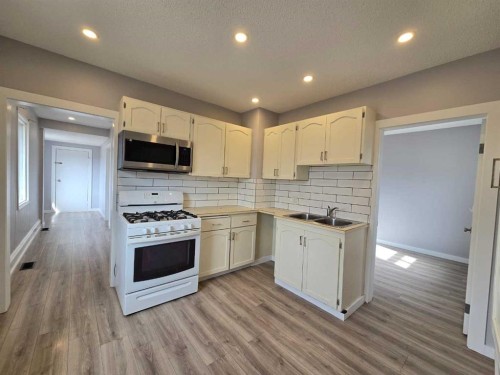 11702 21St Avenue, Blairmore, AB - Indoor Photo Showing Kitchen With Double Sink
