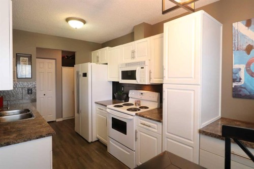 8-1739 St Edward Boulevard North, Lethbridge, AB - Indoor Photo Showing Kitchen With Double Sink