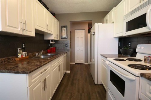8-1739 St Edward Boulevard North, Lethbridge, AB - Indoor Photo Showing Kitchen With Double Sink