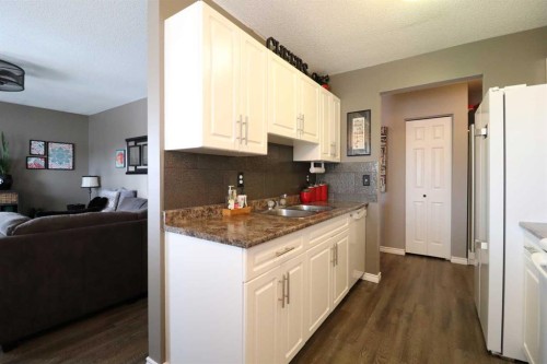 8-1739 St Edward Boulevard North, Lethbridge, AB - Indoor Photo Showing Kitchen With Double Sink