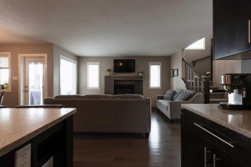 26 Riverglen Link West, Lethbridge, AB - Indoor Photo Showing Living Room With Fireplace