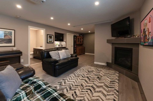 26 Riverglen Link West, Lethbridge, AB - Indoor Photo Showing Living Room With Fireplace