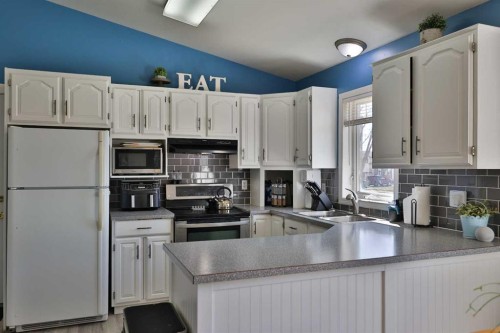 235 E 200 S, Raymond, AB - Indoor Photo Showing Kitchen With Double Sink