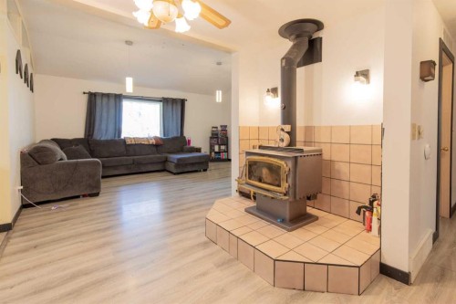 63004A Hwy 5, Welling, AB - Indoor Photo Showing Other Room With Fireplace