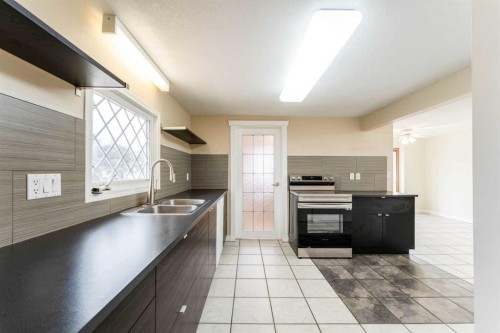 437 Main Street, Milk River, AB - Indoor Photo Showing Kitchen With Double Sink
