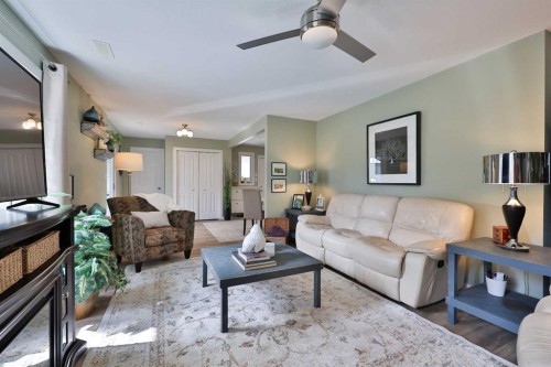 28 E 100 S, Raymond, AB - Indoor Photo Showing Living Room With Fireplace