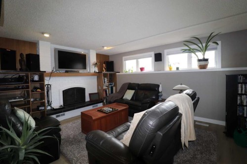 4209 22 Avenue South, Lethbridge, AB - Indoor Photo Showing Living Room With Fireplace