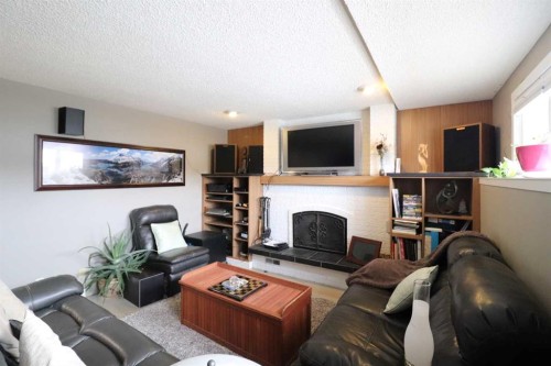 4209 22 Avenue South, Lethbridge, AB - Indoor Photo Showing Living Room With Fireplace