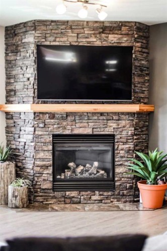 75 Ironstone Drive, Coleman, AB - Indoor Photo Showing Living Room With Fireplace