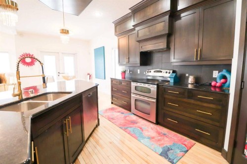 4 Heritage Point West, Lethbridge, AB - Indoor Photo Showing Kitchen With Double Sink