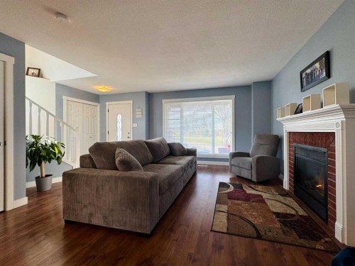 86 Riverstone Boulevard West, Lethbridge, AB - Indoor Photo Showing Living Room With Fireplace