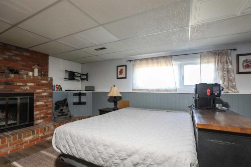 97 Laval Court West, Lethbridge, AB - Indoor Photo Showing Bedroom With Fireplace