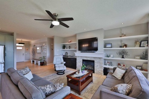397 S 250 W, Raymond, AB - Indoor Photo Showing Living Room With Fireplace