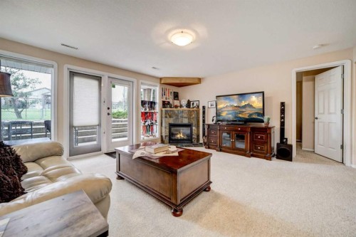 50 Sarcee Place West, Lethbridge, AB - Indoor Photo Showing Living Room With Fireplace