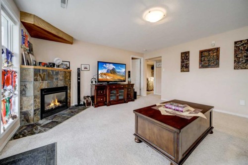50 Sarcee Place West, Lethbridge, AB - Indoor Photo Showing Living Room With Fireplace