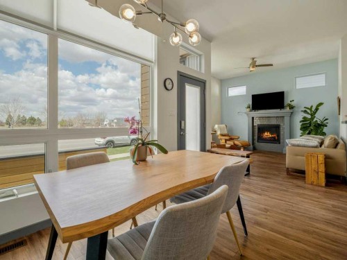 350 Uplands Boulevard North, Lethbridge, AB - Indoor Photo Showing Dining Room With Fireplace
