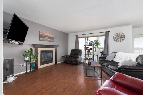 1917 Parkside Point, Coaldale, AB - Indoor Photo Showing Living Room With Fireplace