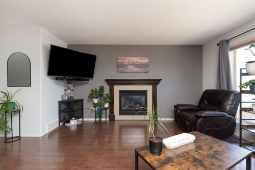 1917 Parkside Point, Coaldale, AB - Indoor Photo Showing Living Room With Fireplace