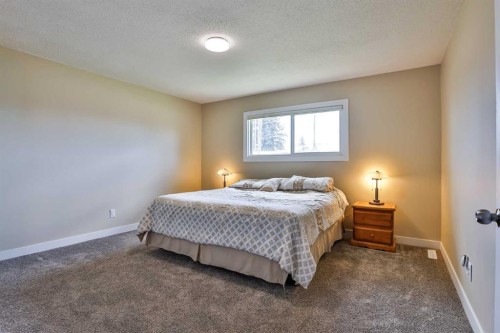 155E 100N, Raymond, AB - Indoor Photo Showing Bedroom