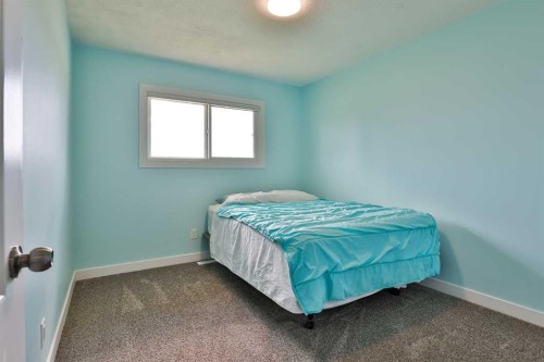 155E 100N, Raymond, AB - Indoor Photo Showing Bedroom