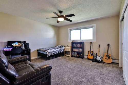 155E 100N, Raymond, AB - Indoor Photo Showing Bedroom