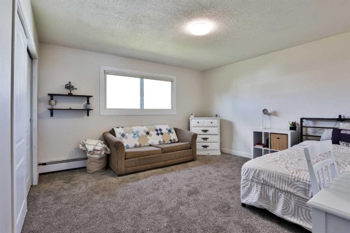 155E 100N, Raymond, AB - Indoor Photo Showing Bedroom