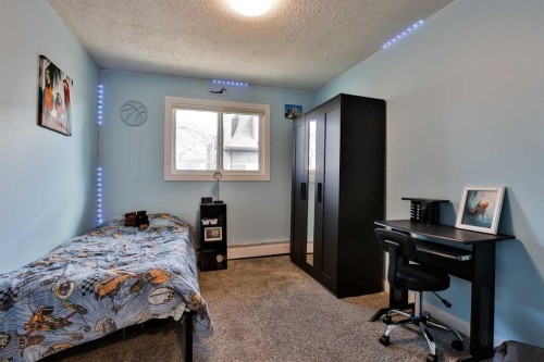 155E 100N, Raymond, AB - Indoor Photo Showing Bedroom