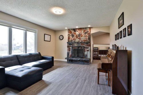 155E 100N, Raymond, AB - Indoor Photo Showing Living Room With Fireplace