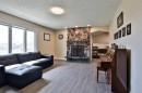 155E 100N, Raymond, AB  - Indoor Photo Showing Living Room With Fireplace 