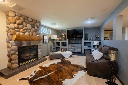 152 Mt Rundle Road West, Lethbridge, AB - Indoor Photo Showing Living Room With Fireplace