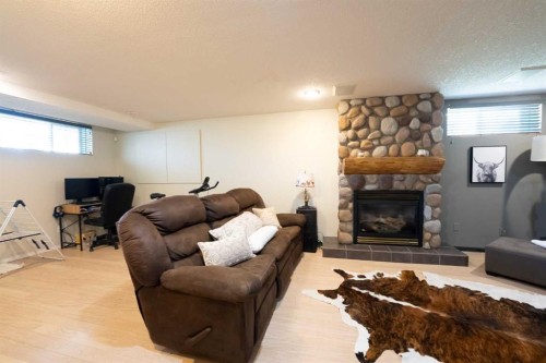 152 Mt Rundle Road West, Lethbridge, AB - Indoor Photo Showing Living Room With Fireplace