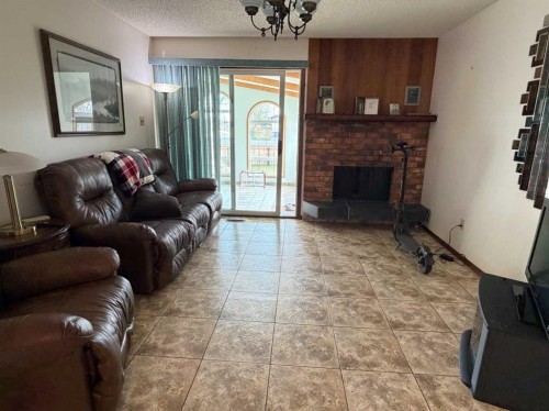 5411 46 Street, Taber, AB - Indoor Photo Showing Living Room With Fireplace