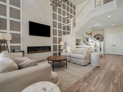 653 Aquitania Boulevard West, Lethbridge, AB - Indoor Photo Showing Living Room With Fireplace