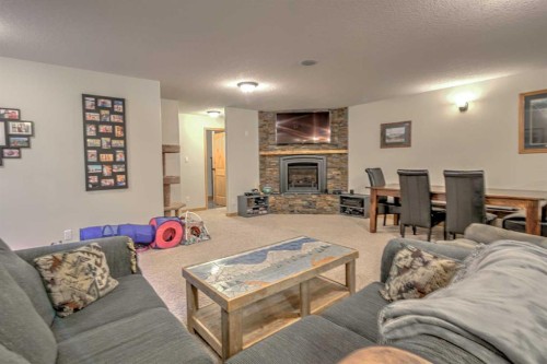 100 Canyoncrest Point West, Lethbridge, AB - Indoor Photo Showing Living Room With Fireplace