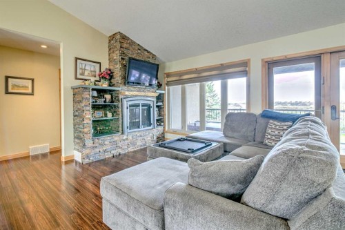 100 Canyoncrest Point West, Lethbridge, AB - Indoor Photo Showing Living Room With Fireplace