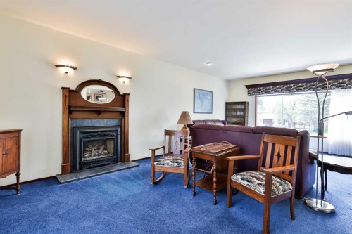 86 Chippewa Crescent West, Lethbridge, AB - Indoor Photo Showing Living Room With Fireplace