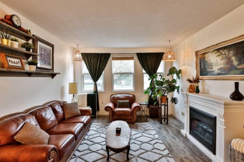 203 Ryerson Road West, Lethbridge, AB - Indoor Photo Showing Living Room With Fireplace