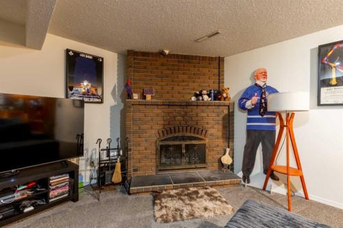 57 Honeysuckle Road North, Lethbridge, AB - Indoor Photo Showing Living Room With Fireplace