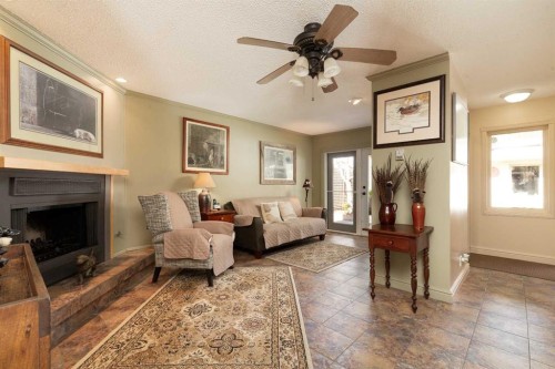 41 Simon Fraser Boulevard West, Lethbridge, AB - Indoor Photo Showing Living Room With Fireplace
